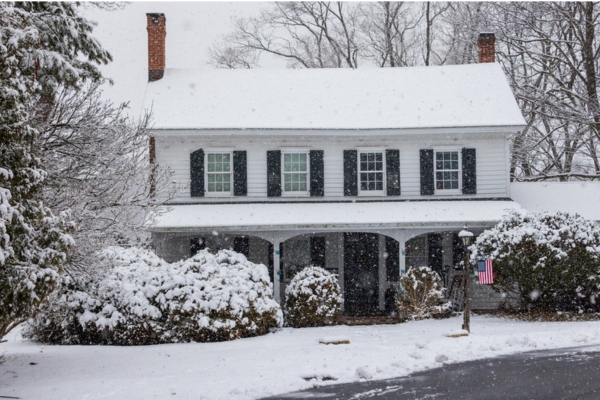 house covered with snow depicting cold outdoor temperature