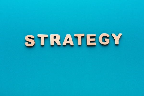 word strategy spelled using wooden letters on blue background depicting oil heating costs
