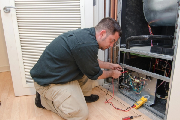 HVAC specialist working on a heating system