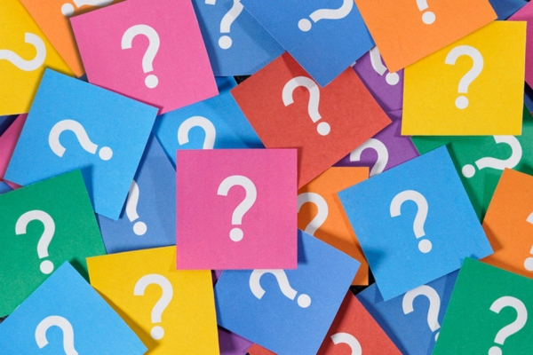 question mark written on colored papers depicting Oil-Fired Hydronic Heating FAQs