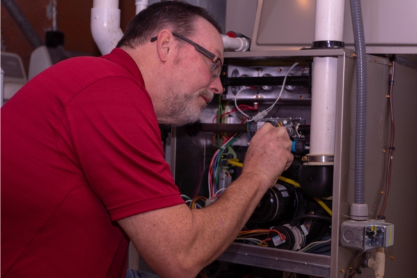 HVAC technician performing furnace diagnosis