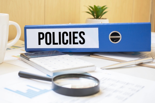 document binder labeled POLICIES