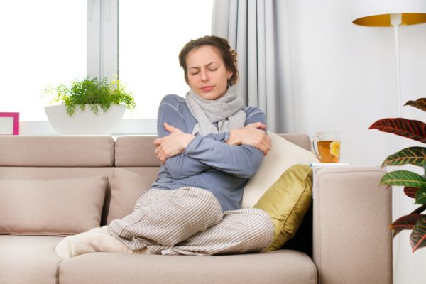 woman feeling cold at home due to hot and cold spots in house