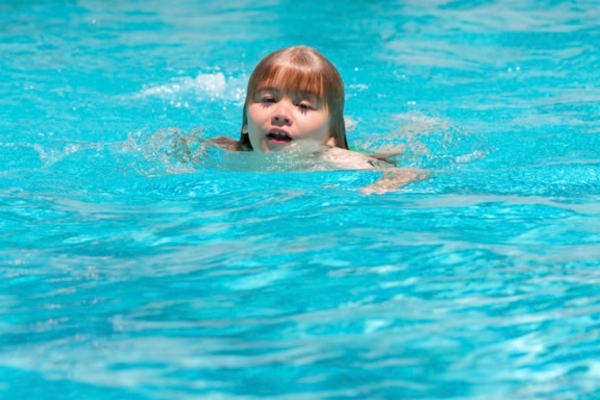 little girl swimming in the pool